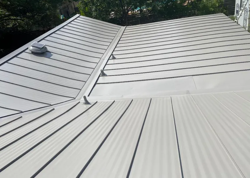 Solar attic fan installed on a metal roof for Roof Ventilation in Druid Hills