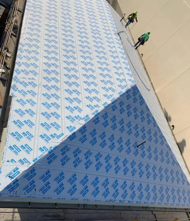 Professional roofers installing underlayment on a metal roof in Druid Hills